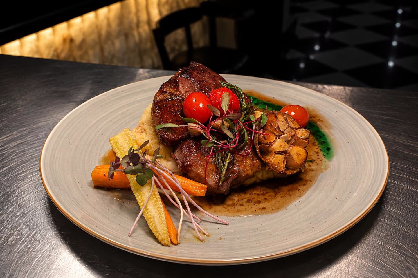 Grilled steak served with vegetables