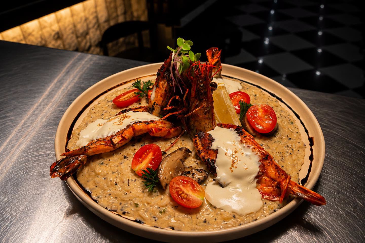 Prawn risotto garnished with tomatoes and greens