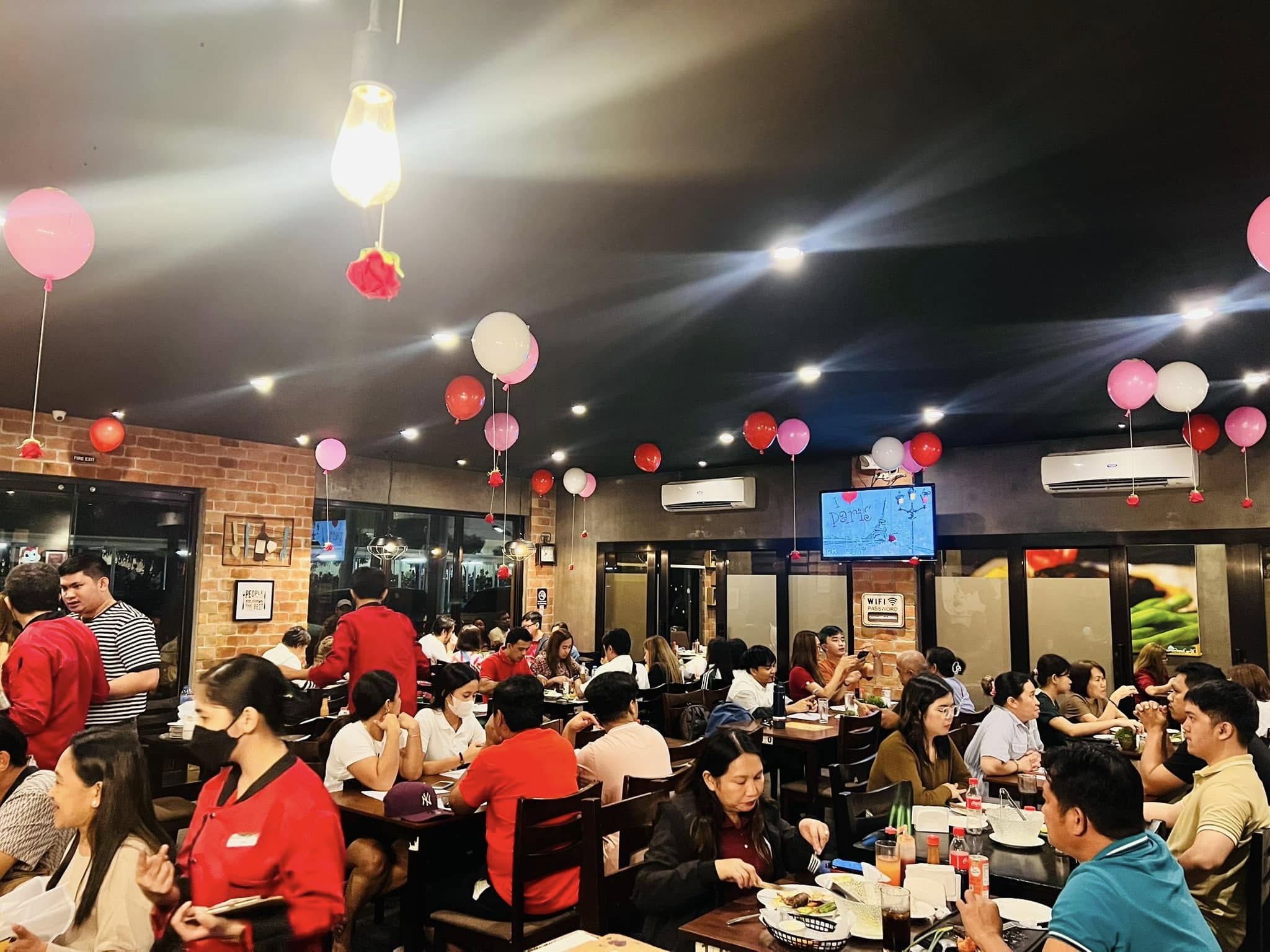 Busy restaurant dining room decorated for a celebration