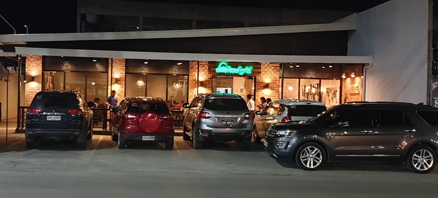 Wide nighttime view of the restaurant storefront