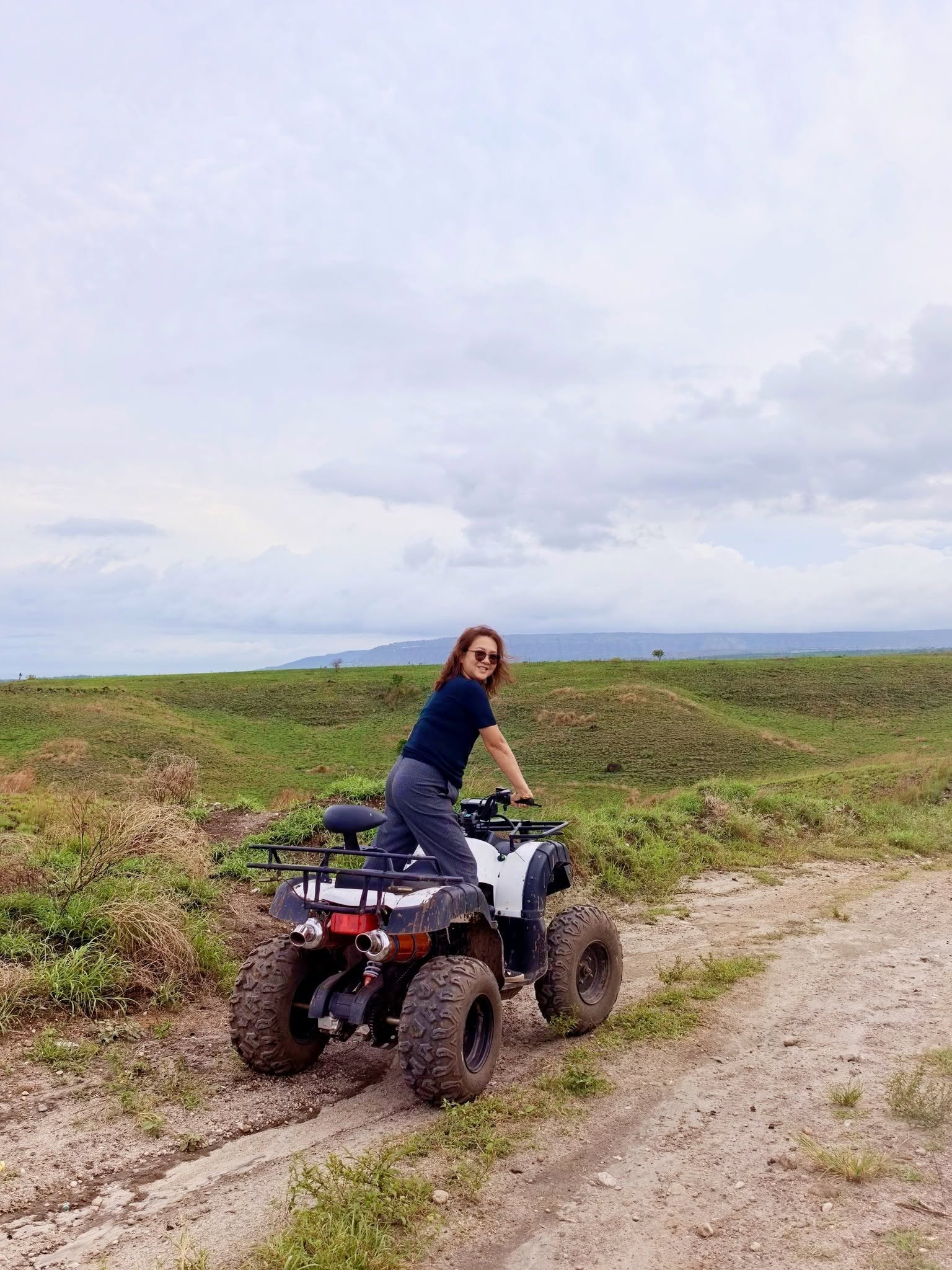 Visitor seated on an ATV along a field track at D’ Garden at Calatao