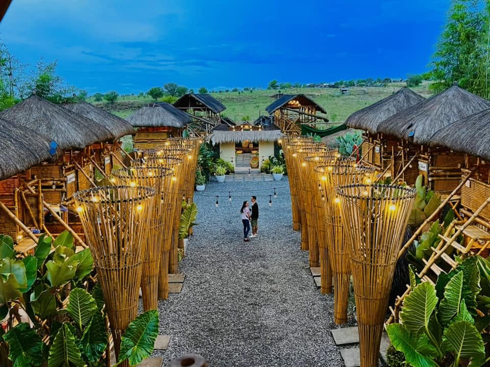 Bamboo structures and a gravel walkway at dusk at D’ Garden at Calatao