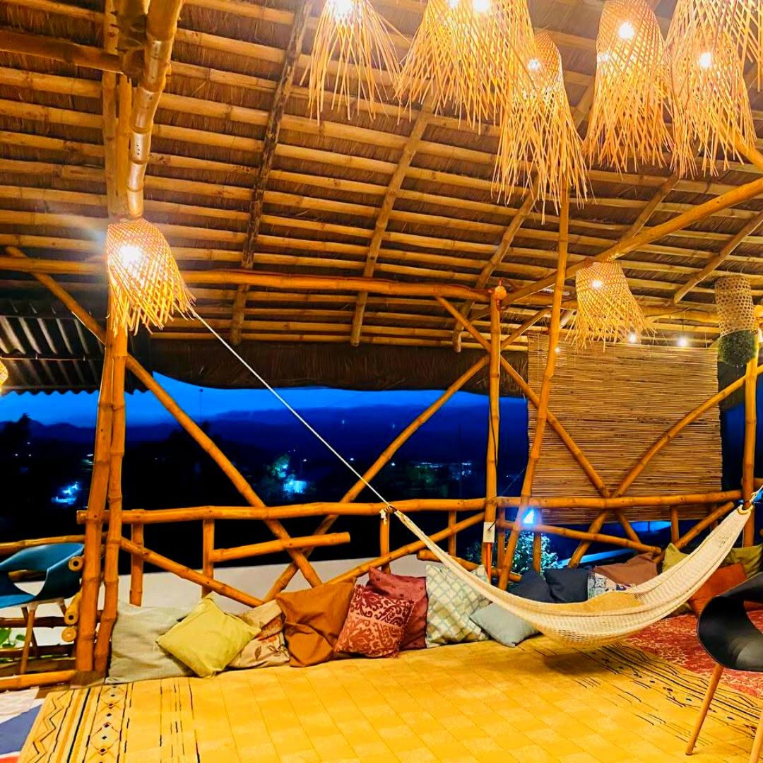 Hammock and cushions beneath woven pendant lights at D’ Garden at Calatao