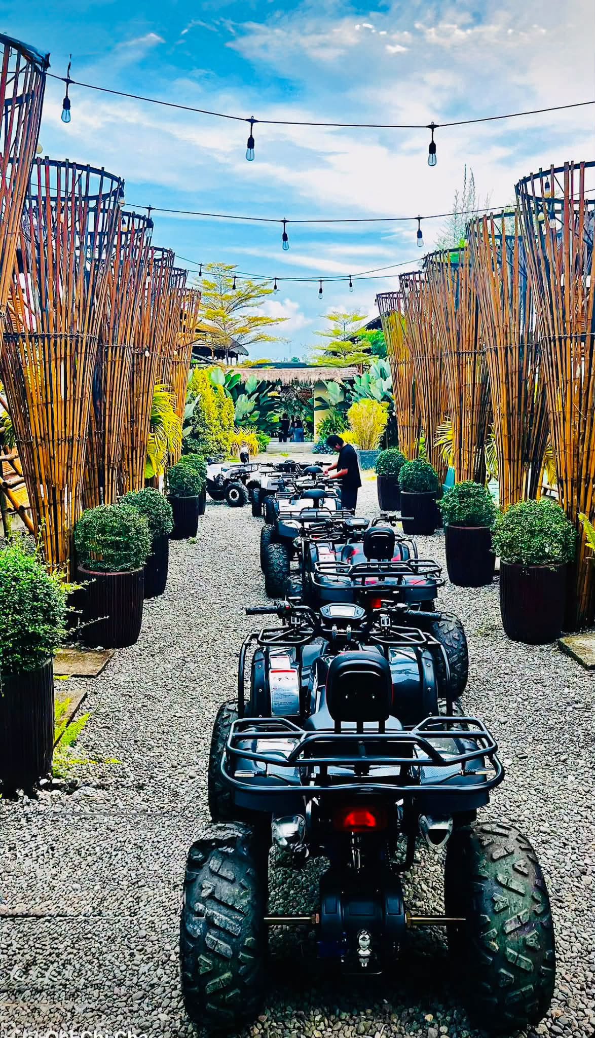 ATVs lined up along a gravel path at D’ Garden at Calatao