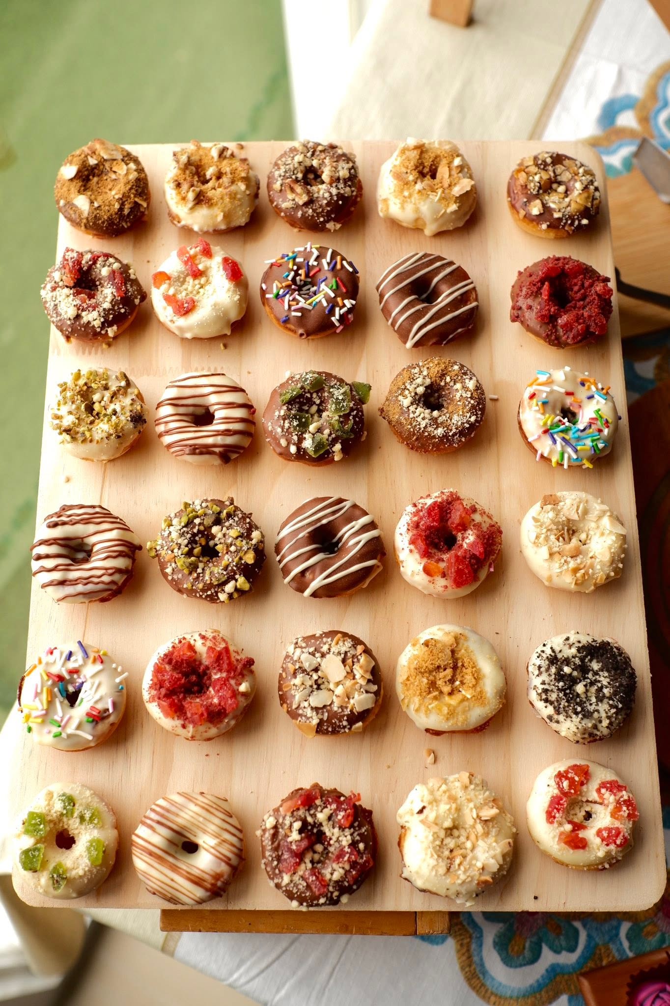 Assorted mini donuts decorated with chocolate and colorful toppings