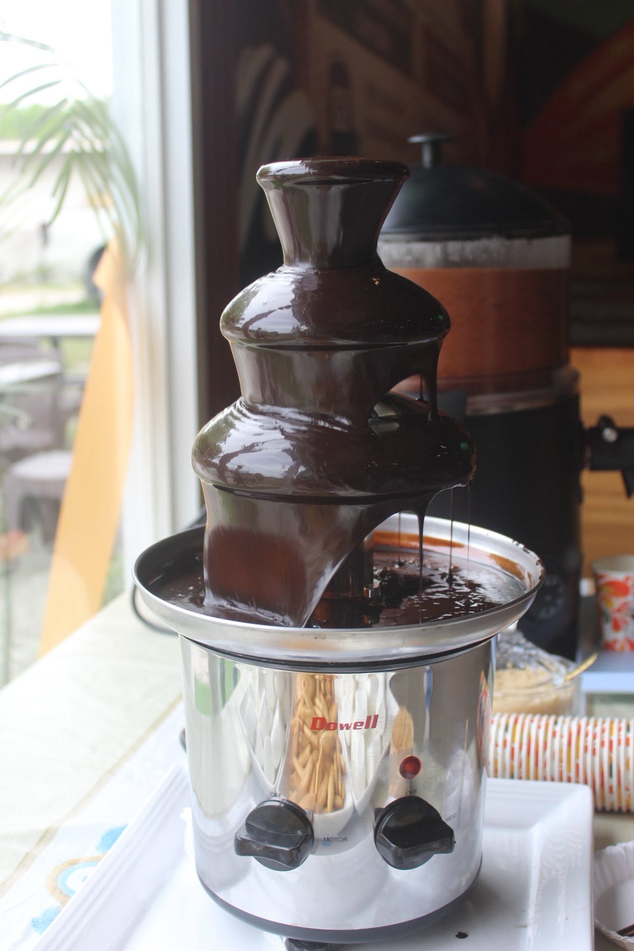 Close view of melted chocolate flowing down a fountain