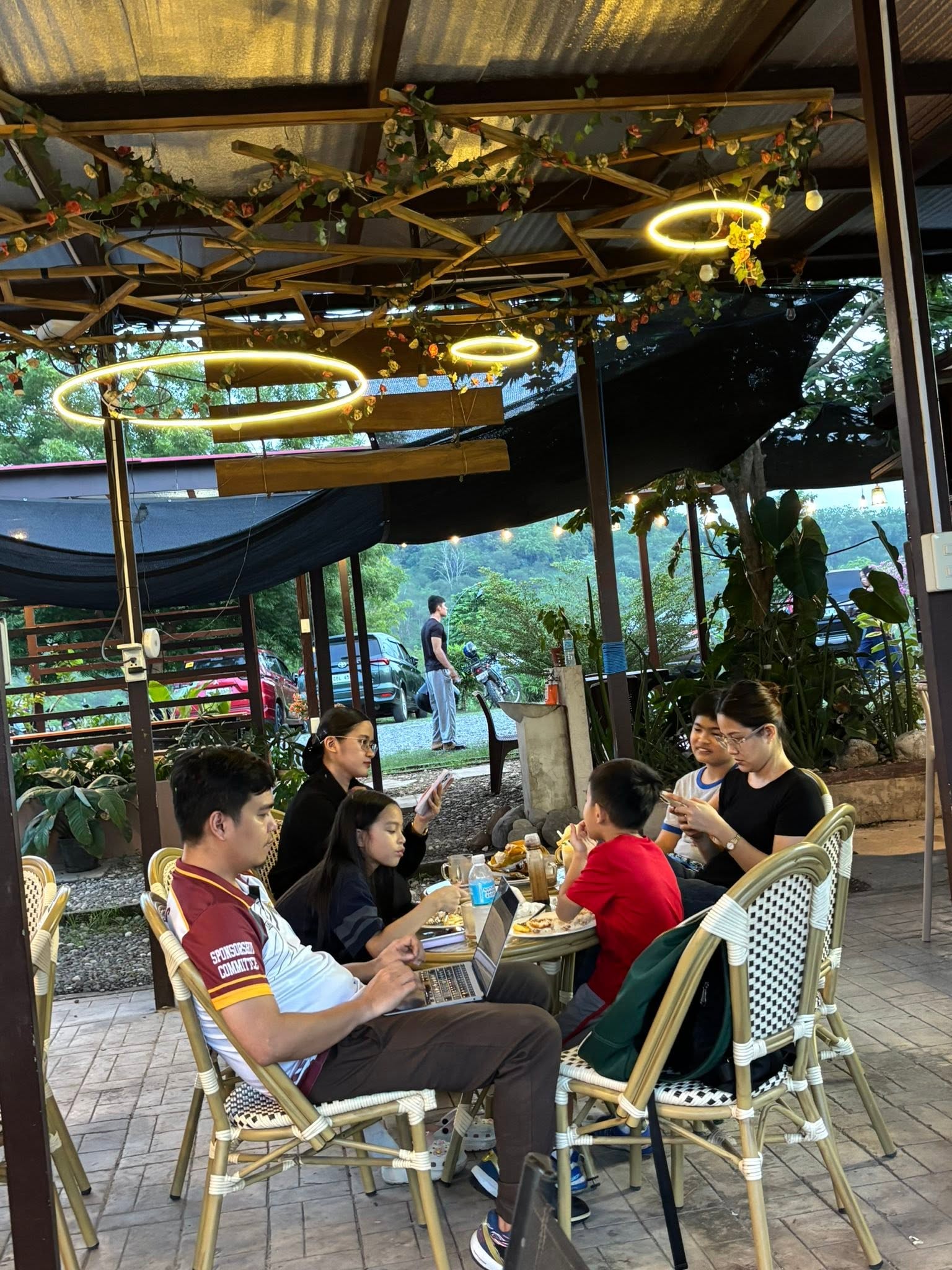 Family seated in the landscaped outdoor café at Don Ricardo