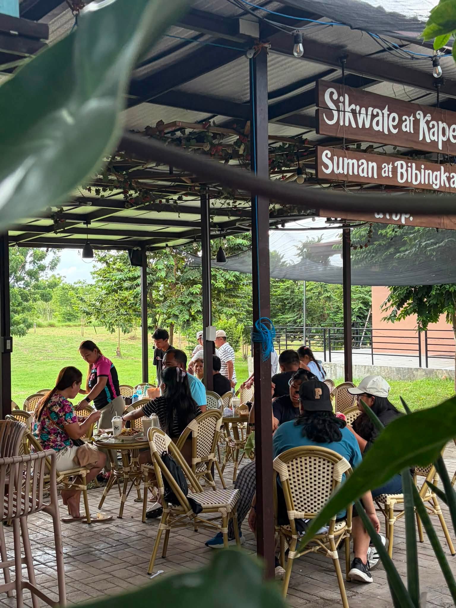 Guests seated in the covered outdoor dining area