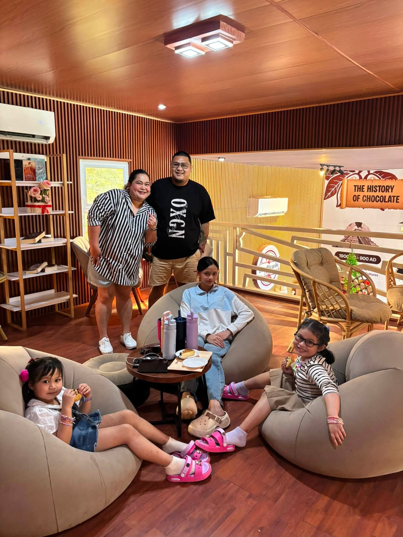 Family relaxing in the warm wood-finished upstairs lounge