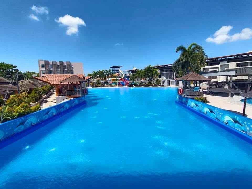 Wide view across the blue wave pool at EmJake Aquawave Resort