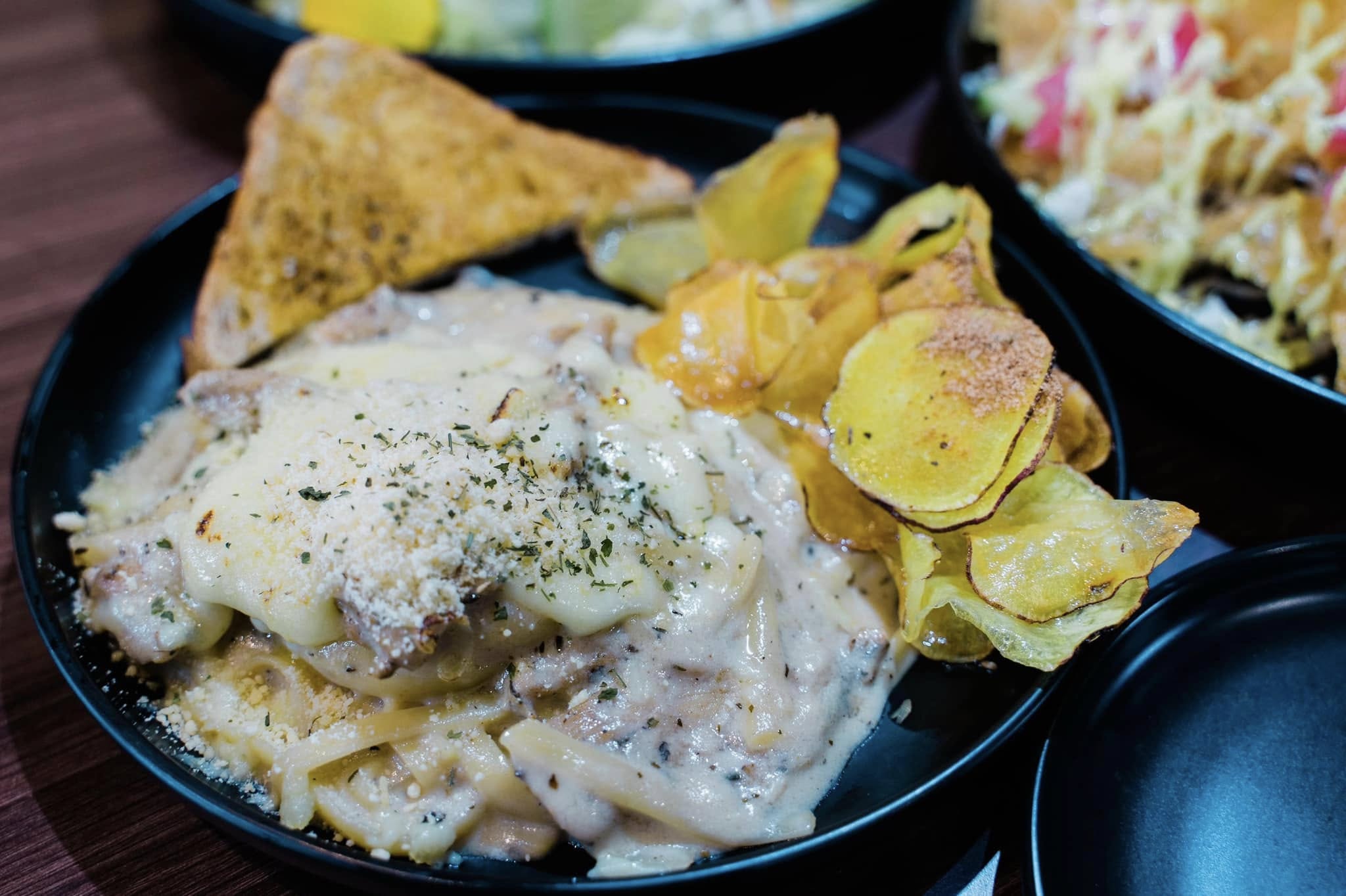 Creamy pasta with toast and chips at Infuzed Cafe Blends