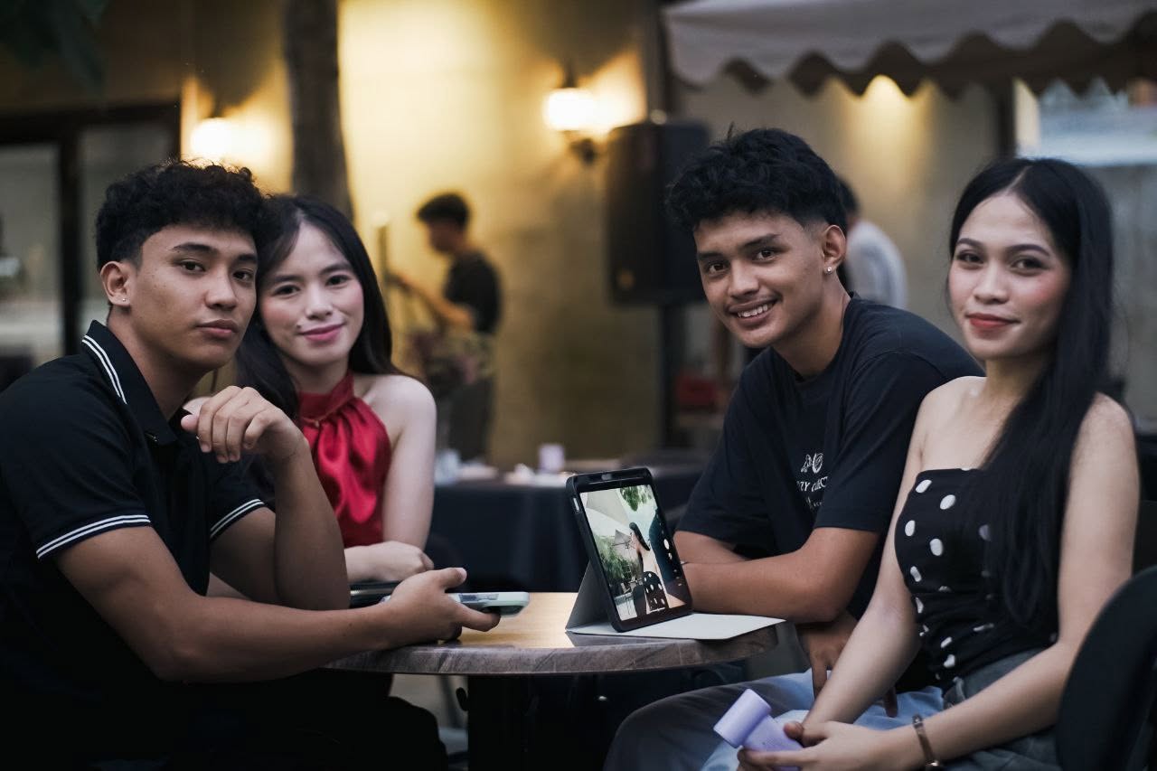 Friends seated at a café table at Infuzed Cafe Blends