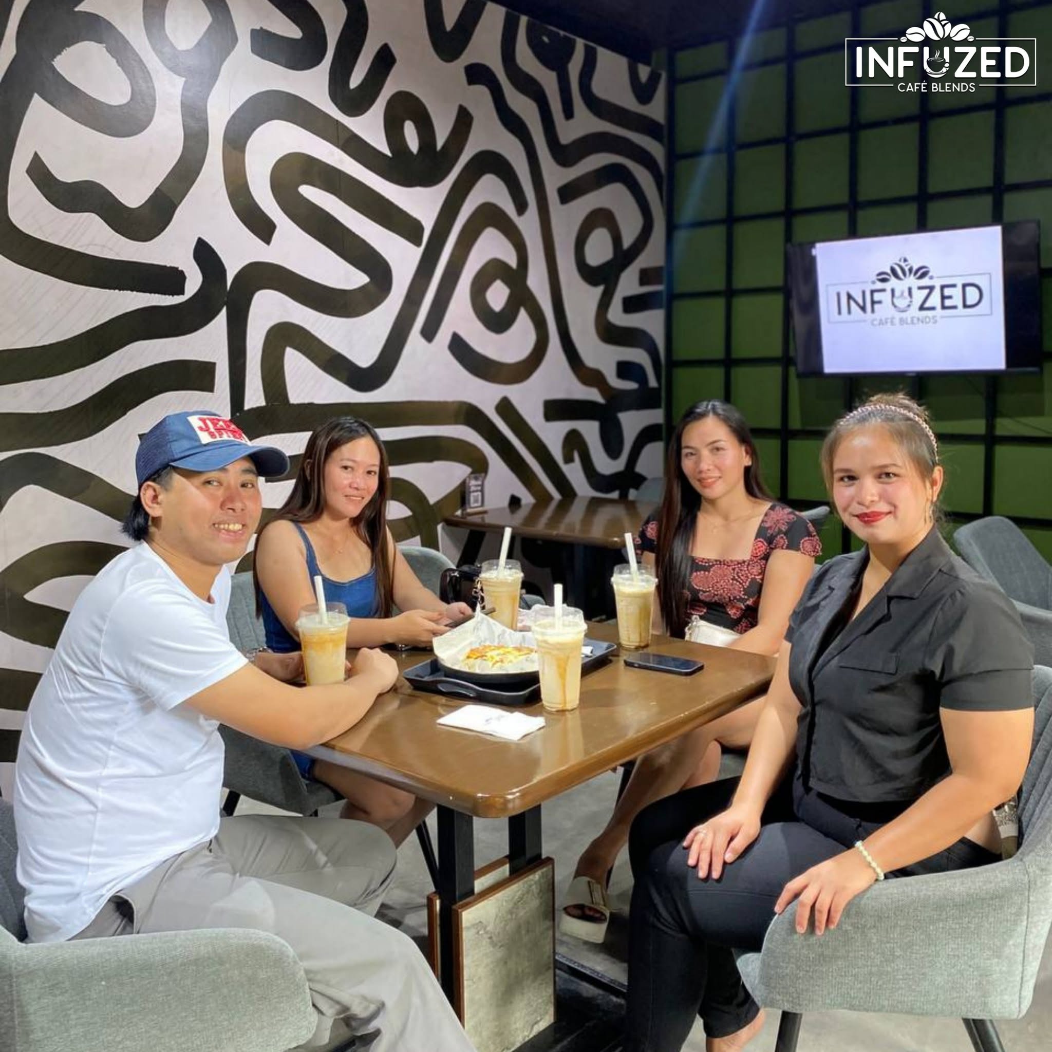 Guests at an indoor table at Infuzed Cafe Blends