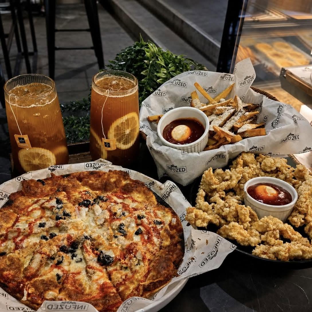 Pizza, fries, and crispy sharing food at Infuzed Cafe Blends