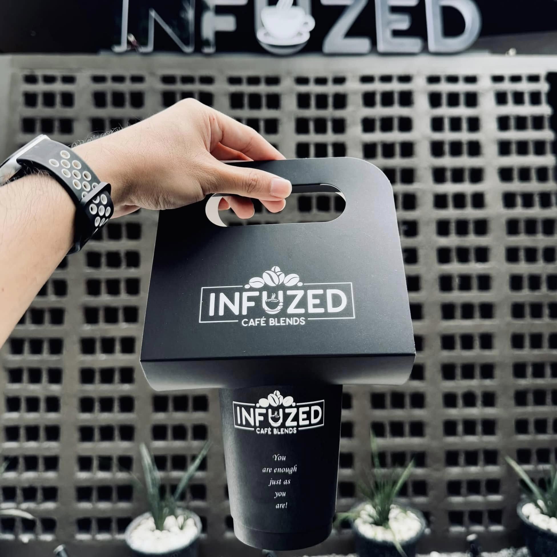 Branded takeaway coffee and carrier at Infuzed Cafe Blends