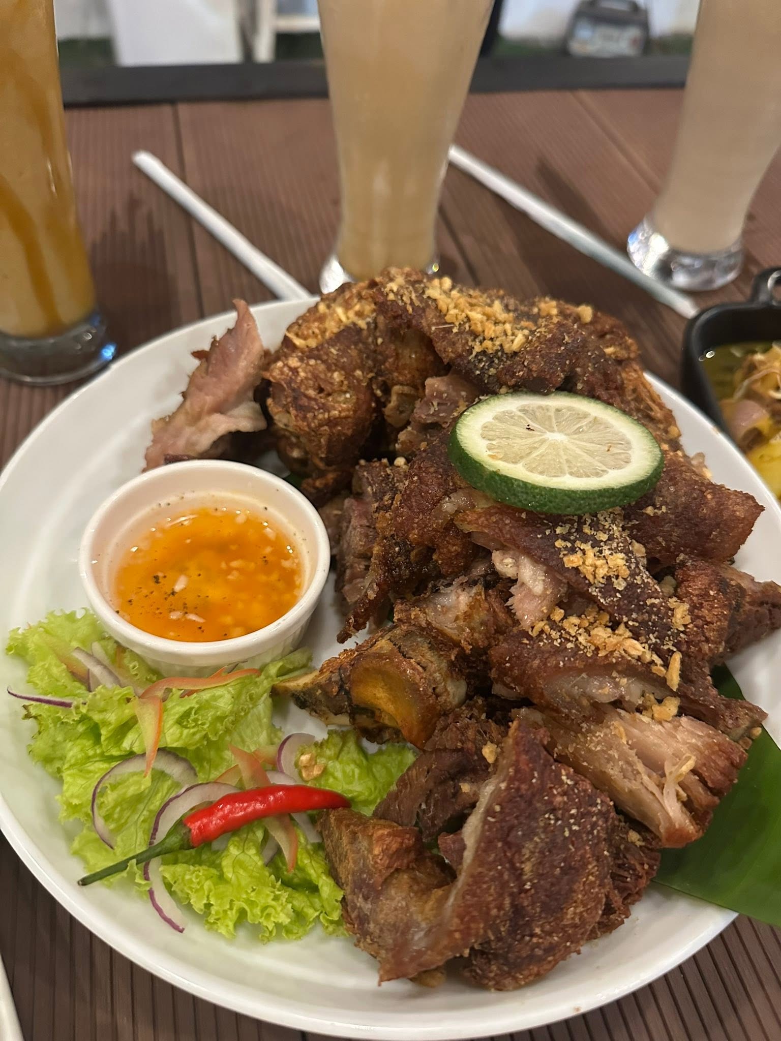 Crispy pork platter with dipping sauce and salad