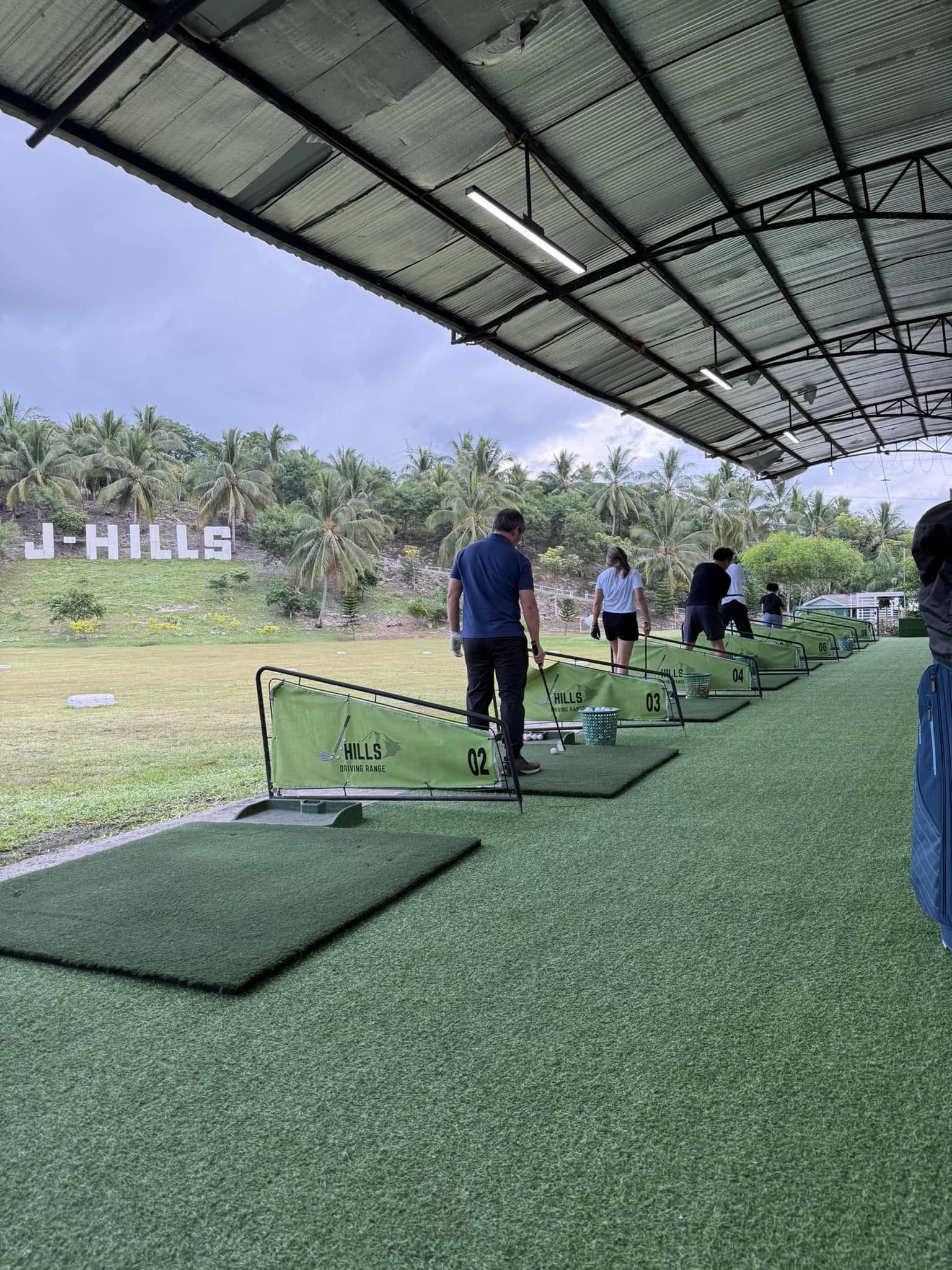 Guests practicing from the covered J-Hills hitting bays during the day