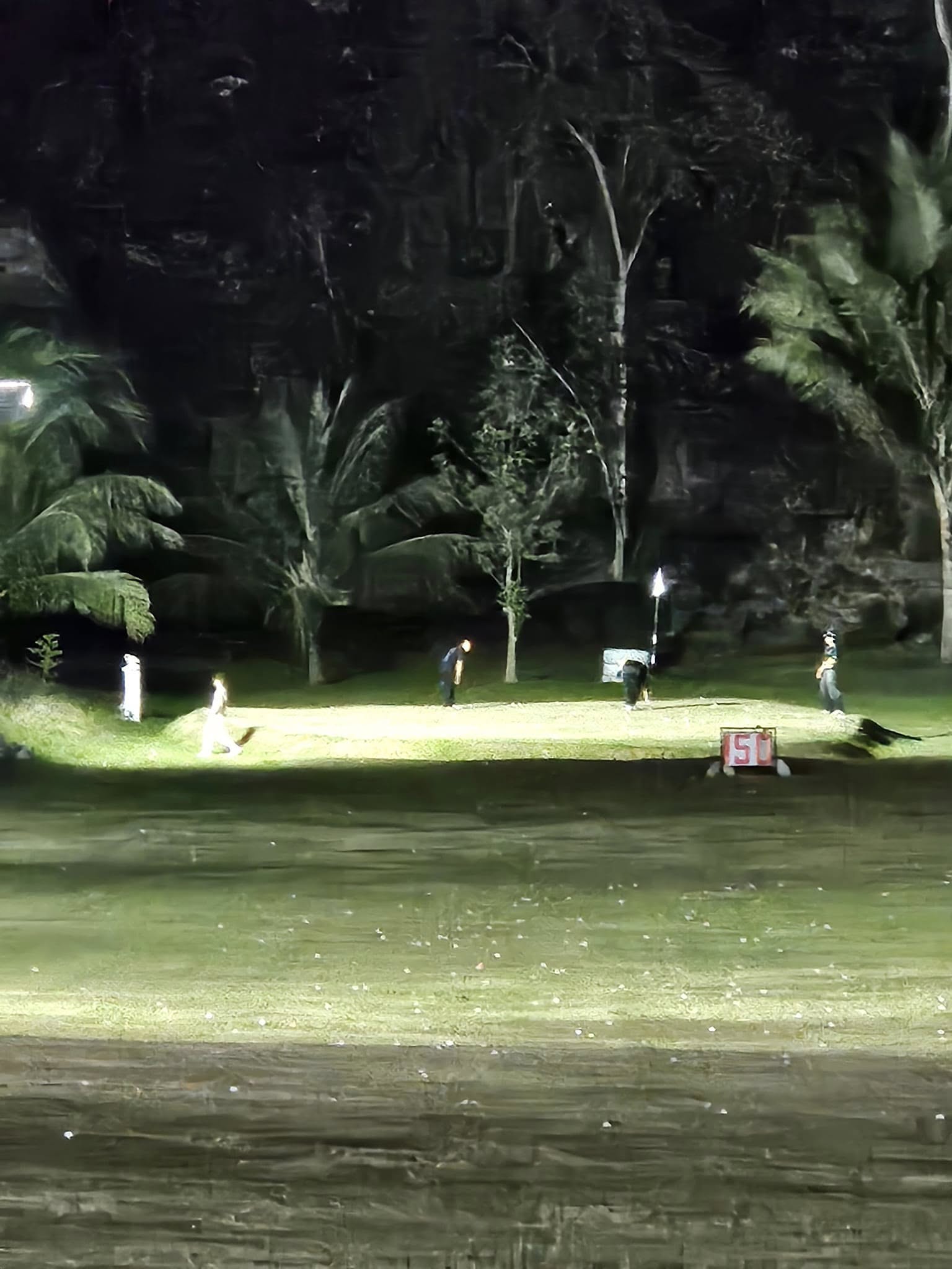Night golf practice near the 50-yard marker at J-Hills