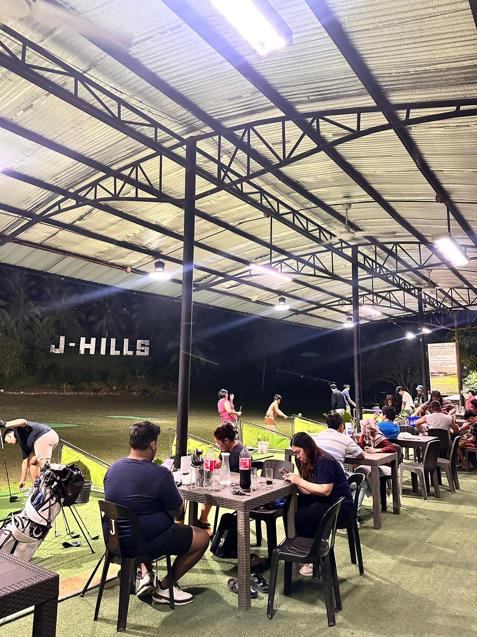 Nighttime golf practice and dining at J-Hills