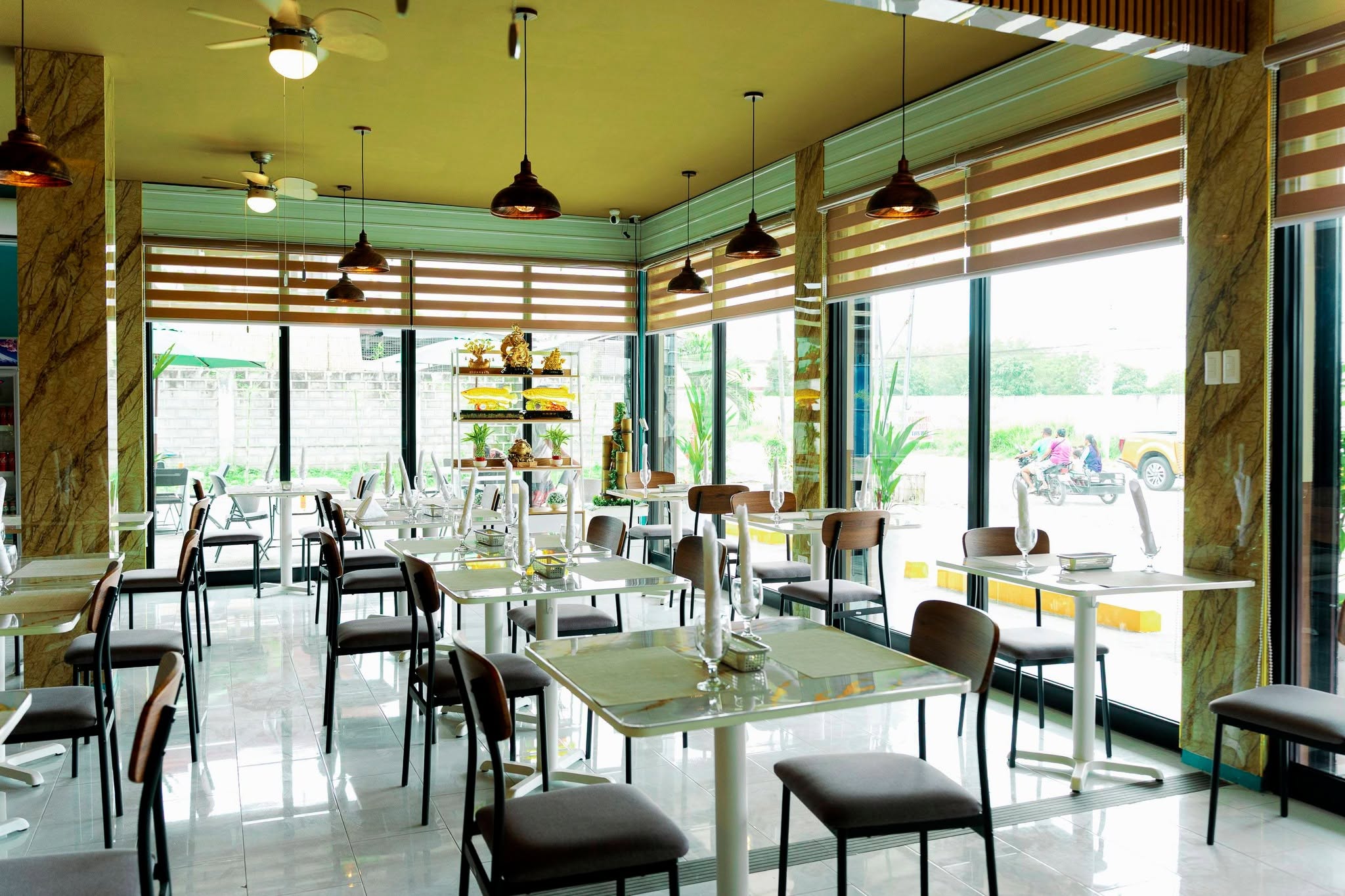 Bright dining room with tables beside large windows