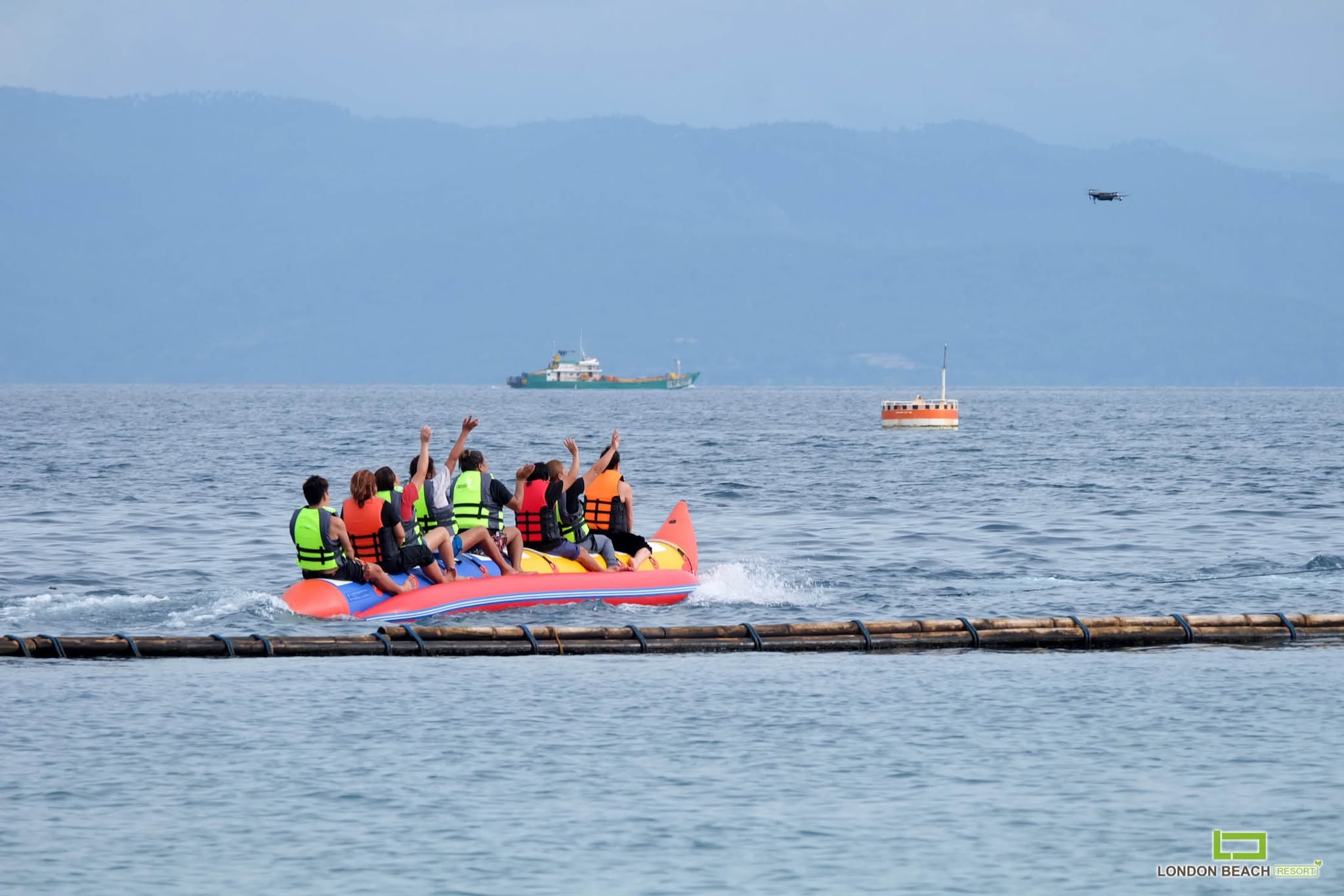 Group enjoying a banana boat ride near London Beach Resort