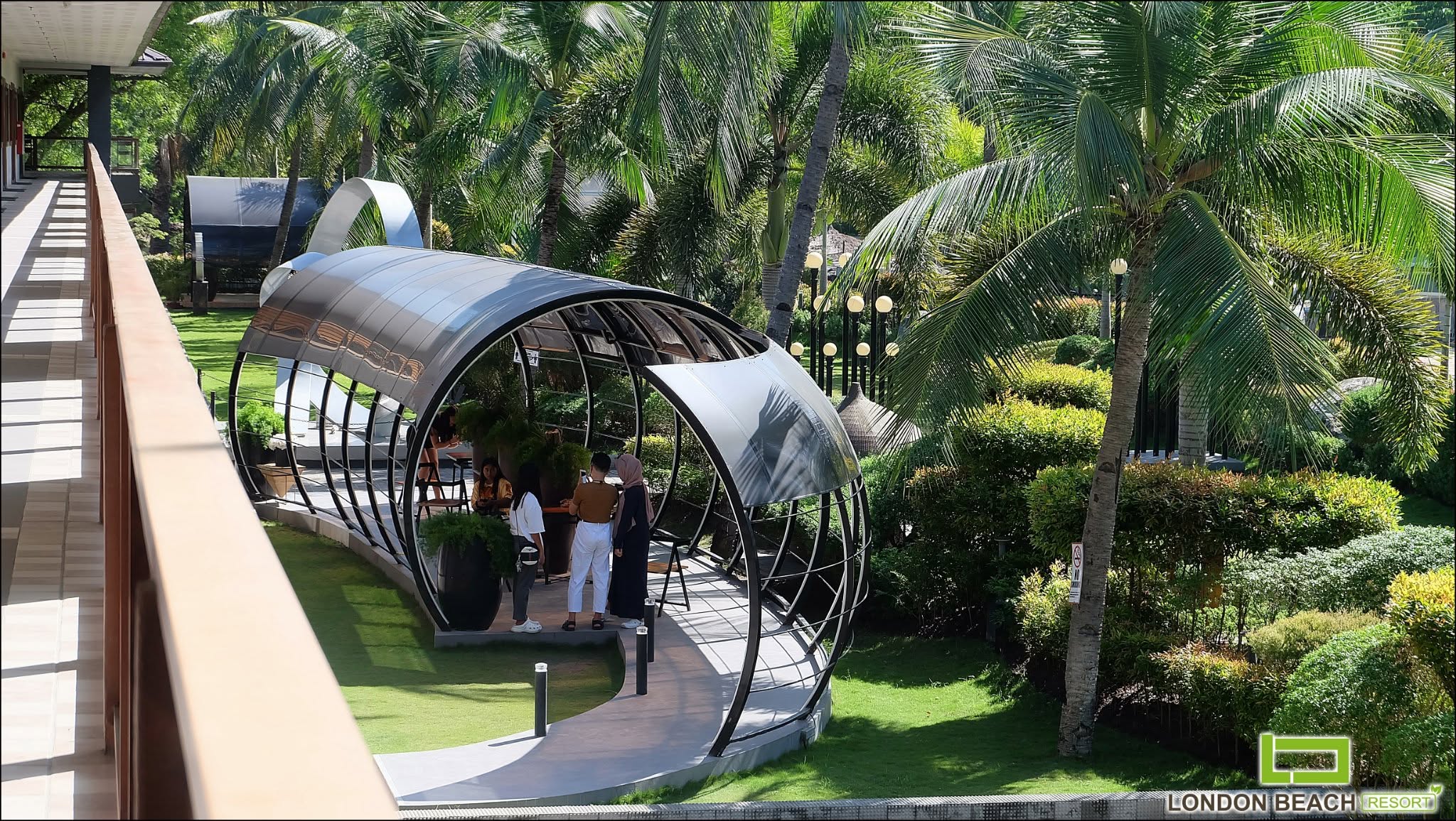 Covered garden lounge surrounded by palms at London Beach Resort