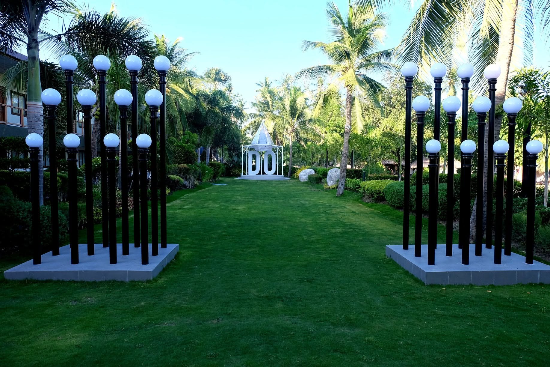 Palm-lined garden lawn at London Beach Resort