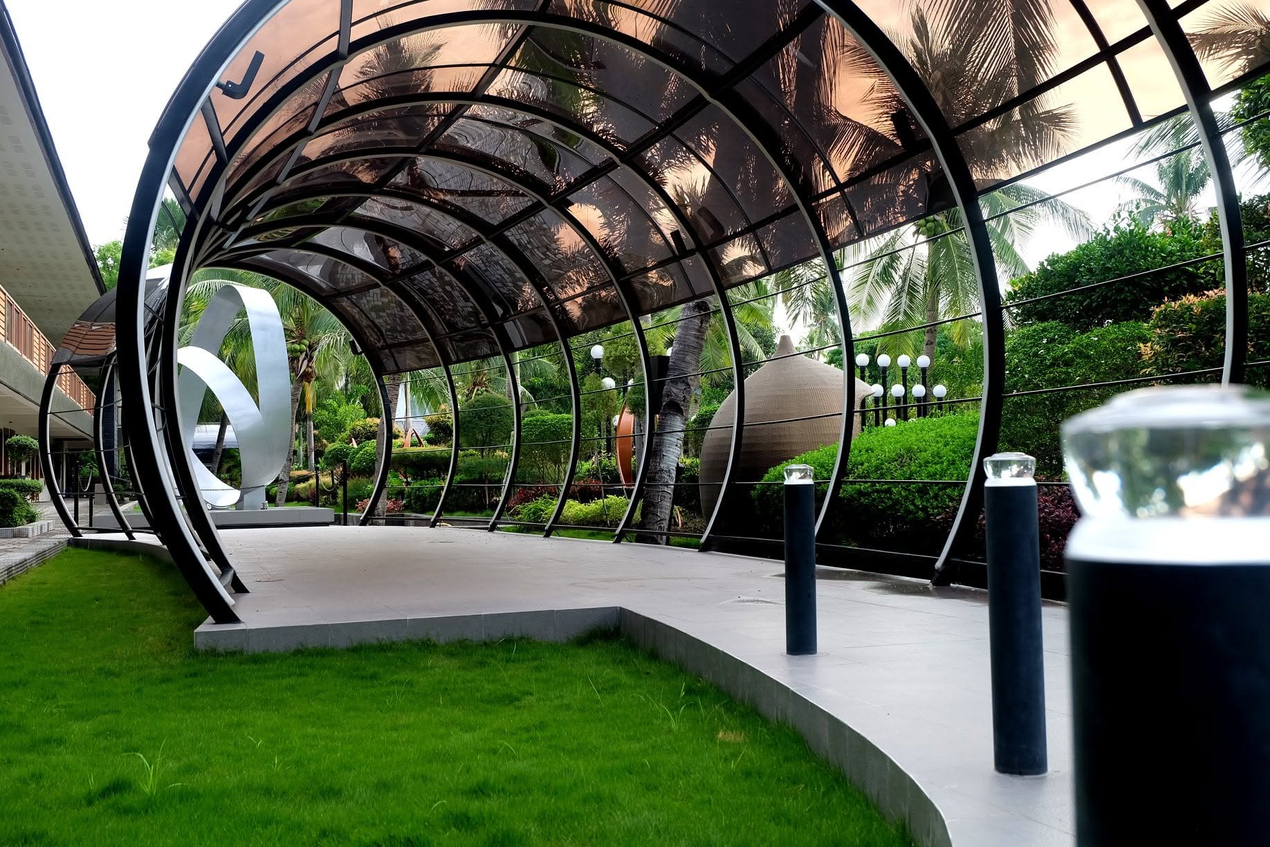Curved covered walkway through the landscaped London Beach Resort grounds