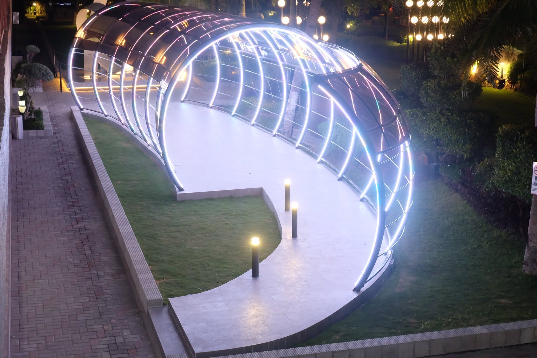 Illuminated covered garden walkway at London Beach Resort