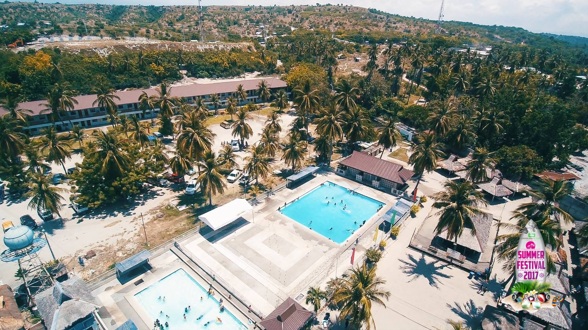 Aerial view of swimming pools and palm-lined grounds at London Beach Resort