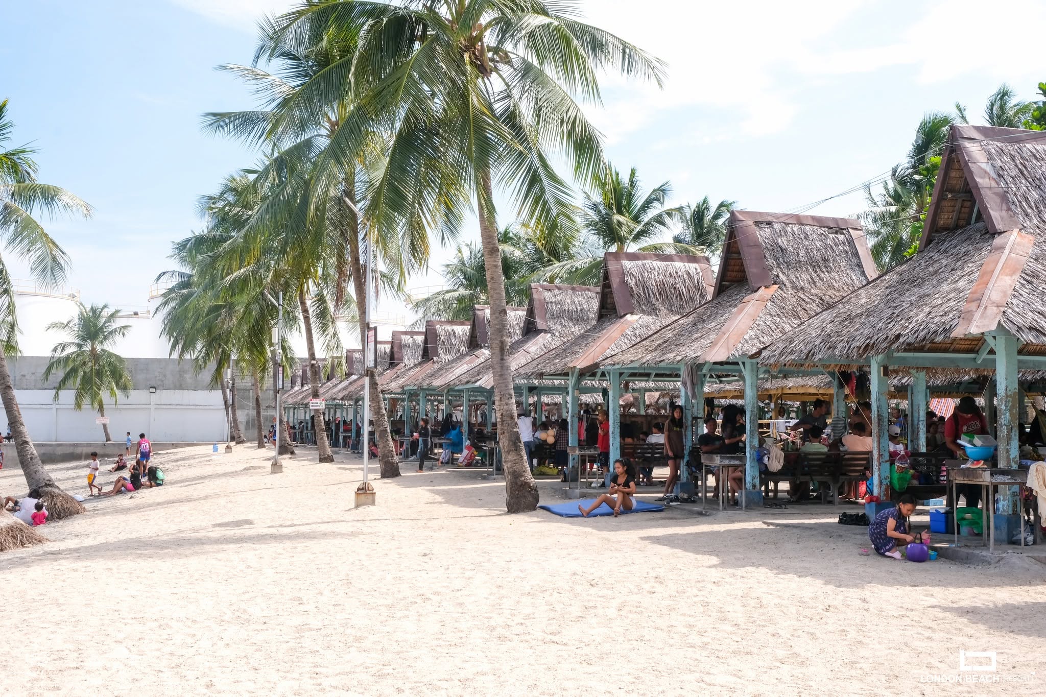 Thatched cottages beside the beach at London Beach Resort