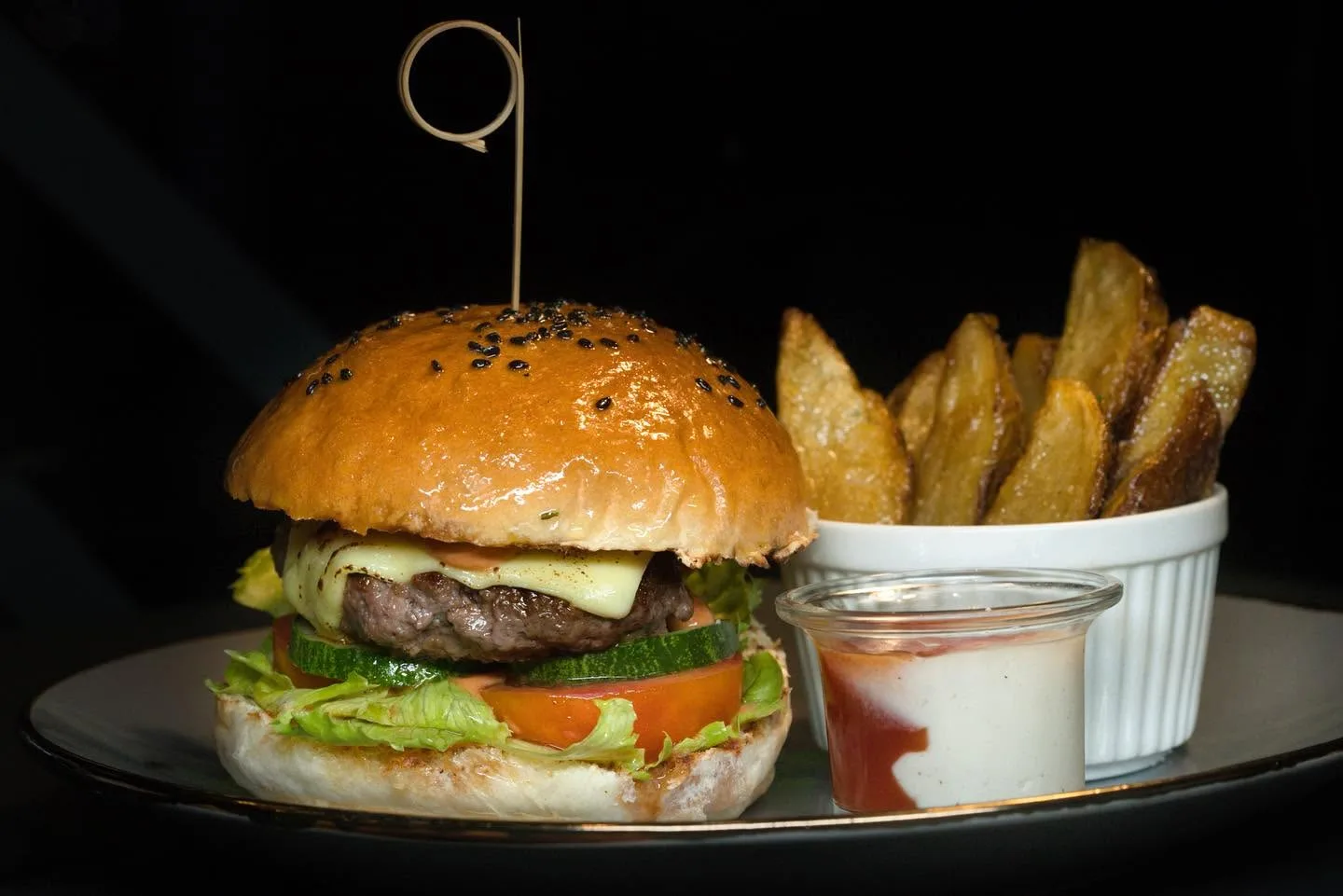 Burger and potato wedges at Nikko's Brew