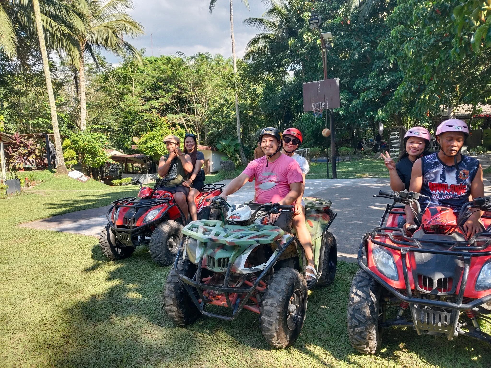 Visitors on ATVs beside the basketball court