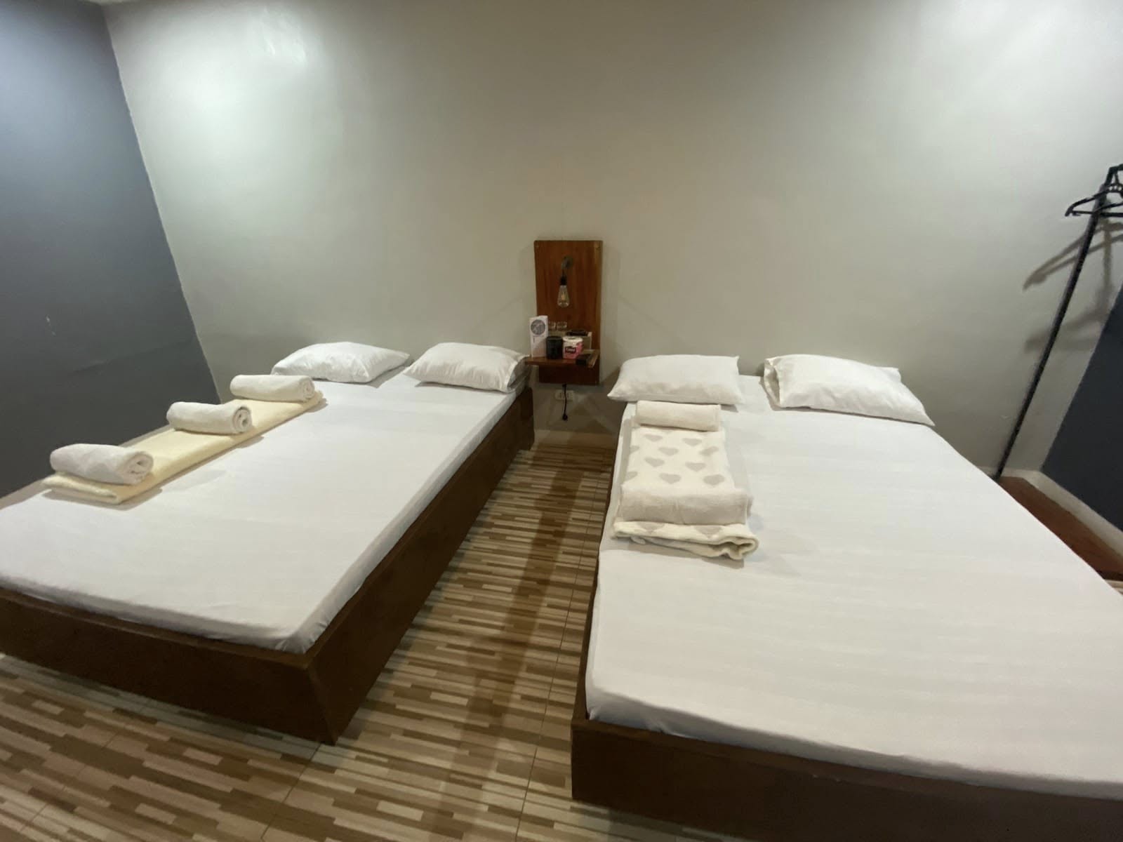 Two beds with folded towels in a River Ranch Resort guest room