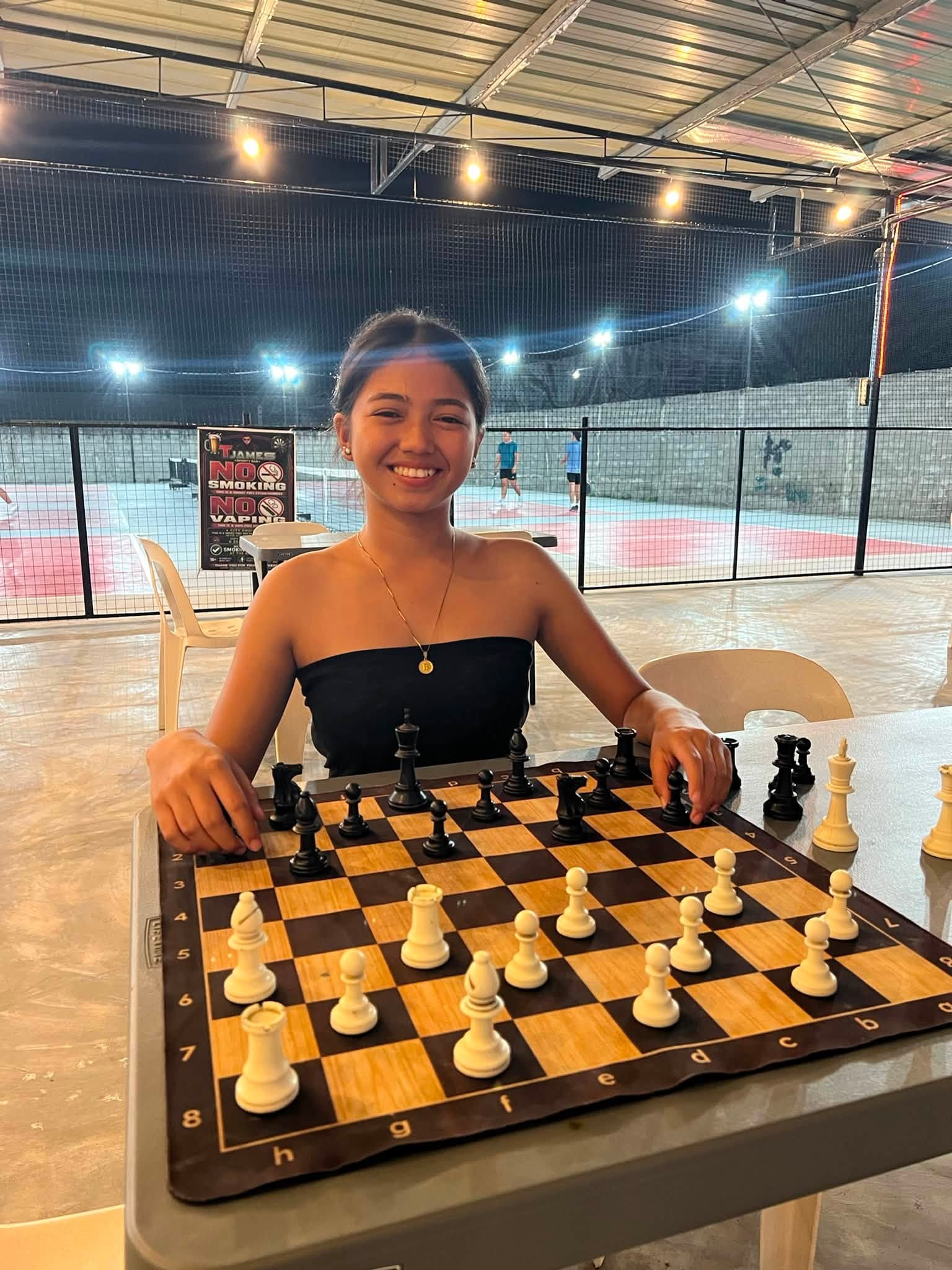 Chess game beside the pickleball courts at T-James Sporty Bar