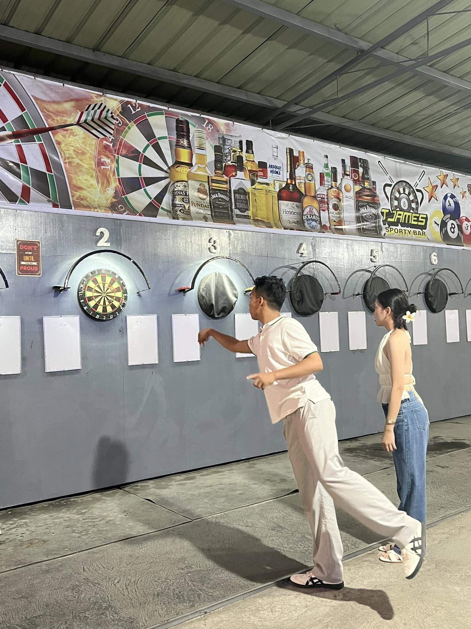 Two guests playing darts at T-James Sporty Bar