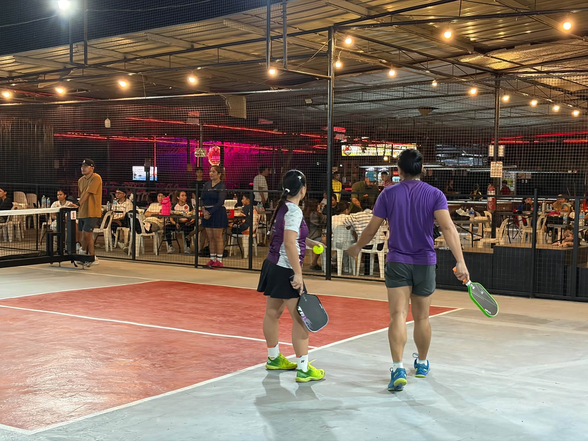 Pickleball players beside the courtside spectators at T-James Sporty Bar