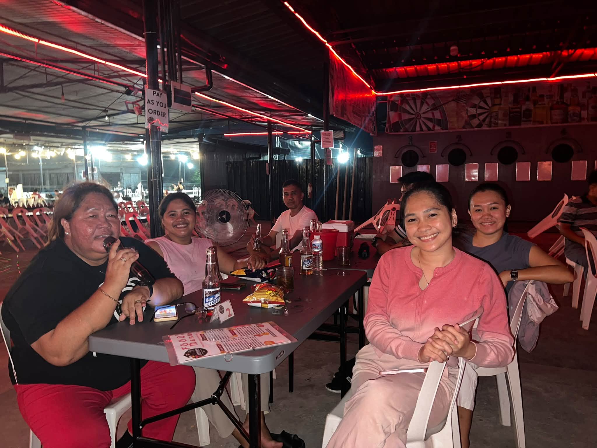 Guests enjoying karaoke and drinks at T-James Sporty Bar