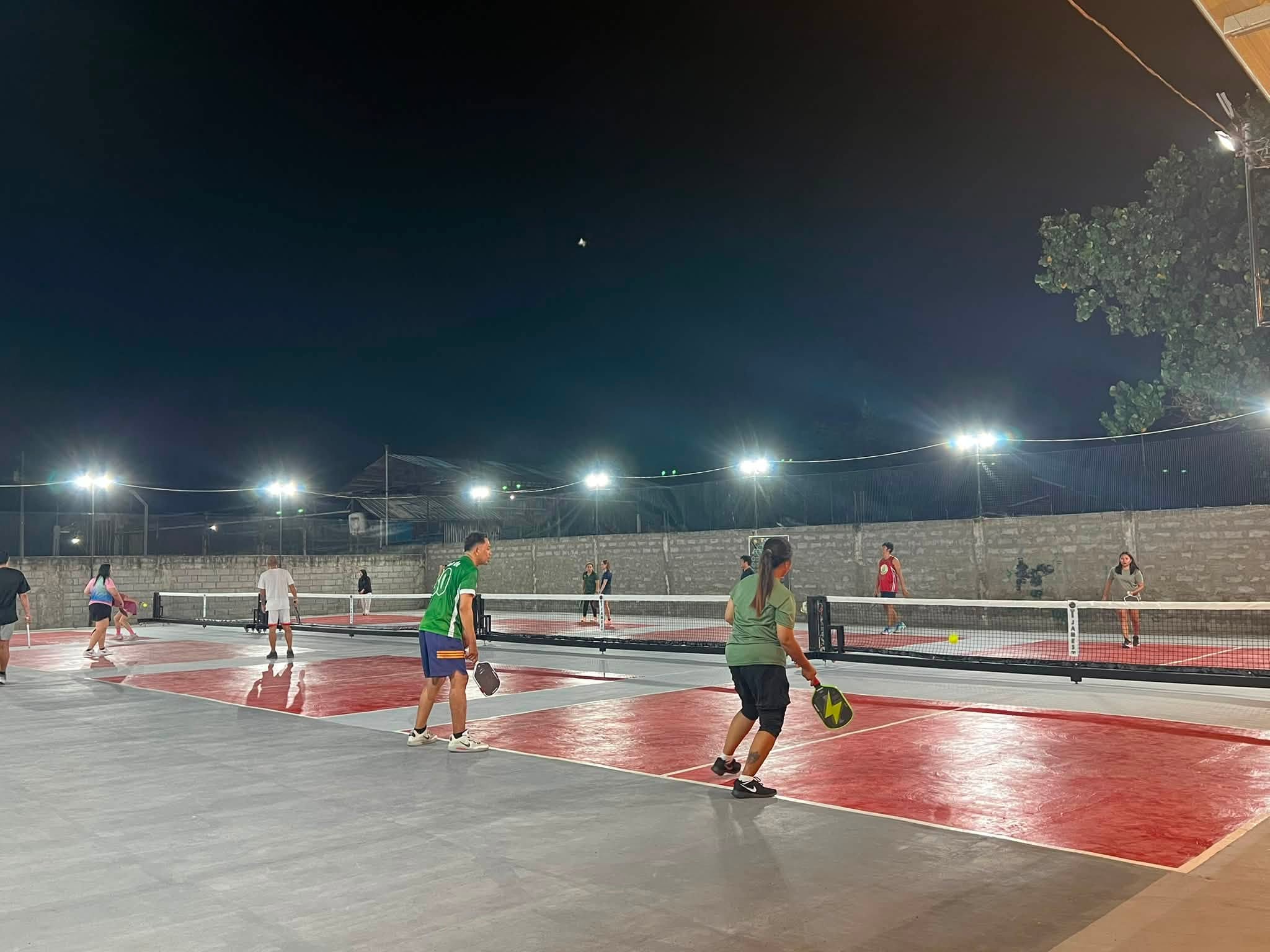 Evening pickleball games across the courts at T-James Sporty Bar